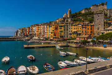 The morning sun highlights the waterfront in Porto Venere, Italy in the summertime