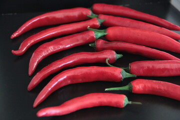 colorful peppers on a black background
