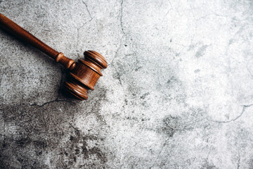 Wooden judge gavel on gray stone background, banner law concept 