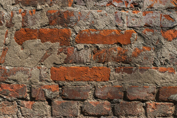 Part of the brick wall of the house during the repair. Texture: bricks and concrete.