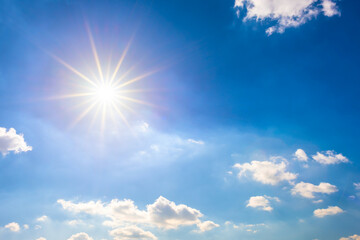 Fototapeta na wymiar Summer background, wonderful blue sky with bright sun and clouds