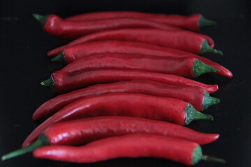 colorful peppers on a black background
