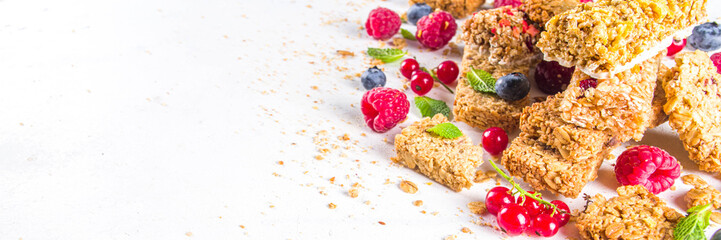 Healthy snack concept,  Cereal granola bars with fresh berries and nuts 