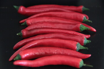 colorful peppers on a black background
