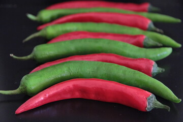 colorful peppers on a black background
