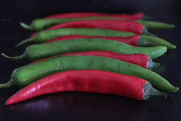 colorful peppers on a black background
