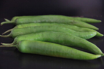 colorful peppers on a black background
