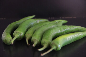 colorful peppers on a black background
