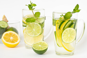 Detox water with lemon, lime, ginger, cucumber and mint in a transparent glass. Healthy lifestyle, proper nutrition.