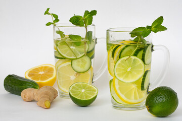 Detox water with lemon, lime, ginger, cucumber and mint in a transparent glass. Healthy lifestyle, proper nutrition.