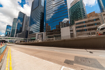 Tall buildings on the sky light rail and ground bus stops.