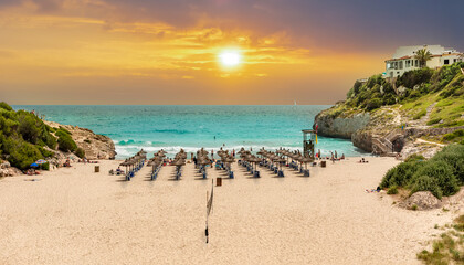 Beautiful vibrant sunrise on the tropical beach on Cala Domingos playa de Mallorca in the summer...