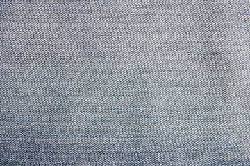 Fototapeta na wymiar Denim jeans light blue texture background. Soft smooth jean fabric, pale blue and white color clothing, blank jeans pattern design