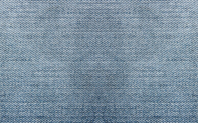 Denim jeans light blue texture background. Soft smooth jean fabric, pale blue and white color clothing, blank jeans pattern design