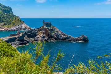 Naklejka premium A view from Doria Castle towards the promontory of the church of Saint Peter in Porto Venere, Italy in the summertime