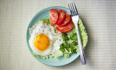 fried egg with tomatoes and parsley on wooden background