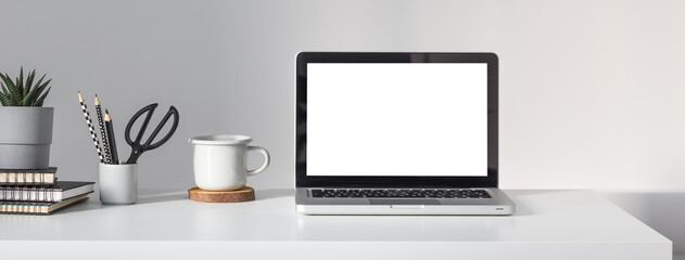 Laptop at minimalist home office desk. Mockup.