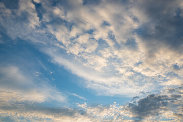 Obraz premium Majestic clouds illuminated by sunrise. Sky background