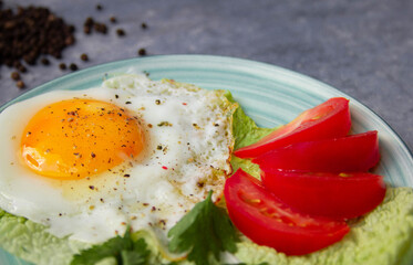 fried egg with tomatoes on marble rock background