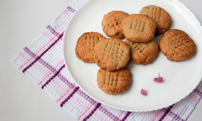homemade peanut cookies with pink flowers on the white background