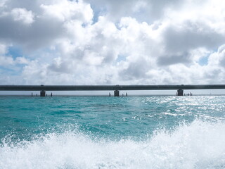 Obraz premium Okinawa,Japan-June 20, 2020: Ikema bridge viewed from a boat passing under the bridge 