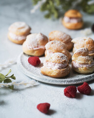 raspberry creampuffs with fresh raspberries and powdered sugar