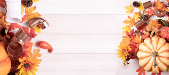 Happy Thanksgiving with construction tools, maple leaves and pumpkin on wood background.
Autumn composition with copy space. Plumber Thanksgiving. Top view.