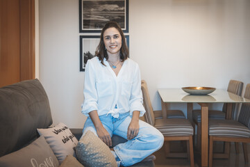 young brazilian woman smiling and relaxing at home