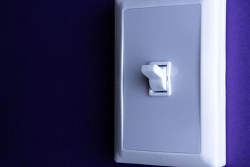 White switch on a blue background in the upper position