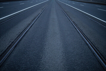 a symmetrical road with rails extending far beyond the horizon