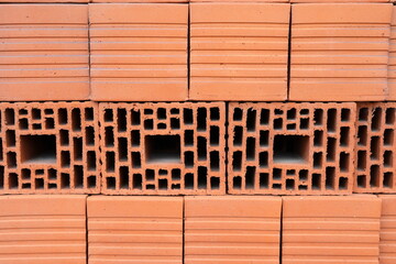 Wall blocks made from red porous ceramics with rectangular holes on a pallet 