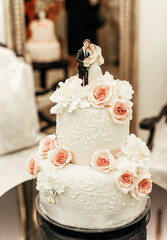 small figures of bride and groom on wedding day. the wedding cake