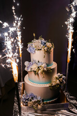 wedding cake with candles and flowers