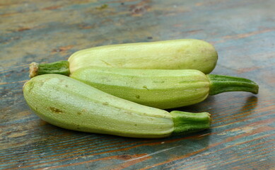 fresh green zucchini on a wooden table.