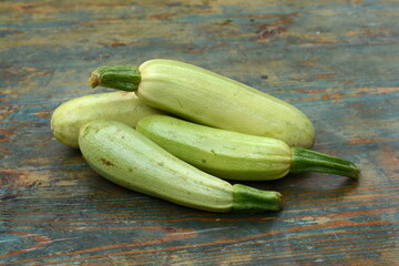 fresh green zucchini on a wooden table.