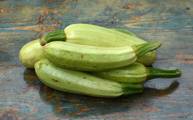 fresh green zucchini on a wooden table.