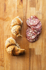 Sliced italian salami with hazelnuts and bun
