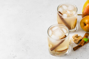 Autumn pear cider cocktail in glasses. Space for text.