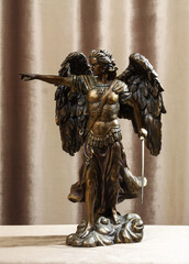 Statuette of the Archangel Michael on a velour background.