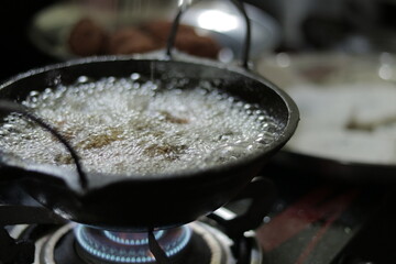 delicious food prepared in hot oil in a kitchen.