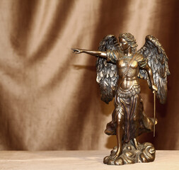 Statuette of the Archangel Michael on a velour background.