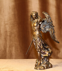Statuette of the Archangel Michael on a velour background.