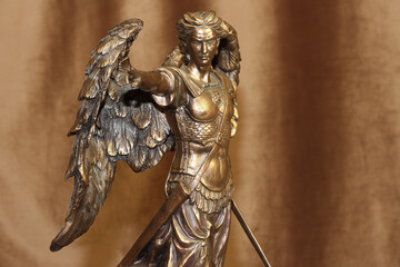 Statuette of the Archangel Michael on a velour background.