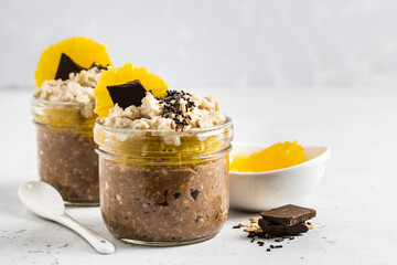 Chocolate chia overnight oats in glasses.  Selective focus, copy space.