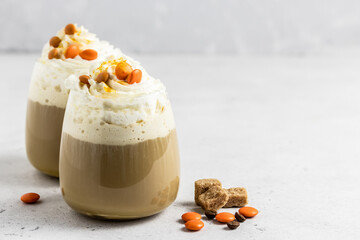 Pumpkin spice latte, whipped cream coffee in glass. Selective focus, copy space.