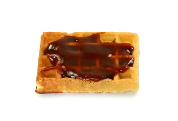 Freshly baked belgian waffles with jam isolated on white background.