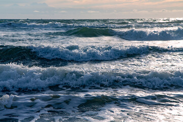 Waves after a storm in the South China Sea at sunset in Mui Ne, Vietnam