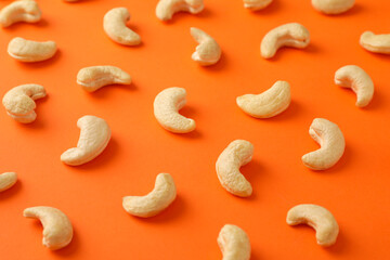 Flat lay with cashew nuts on orange background. Vitamin food