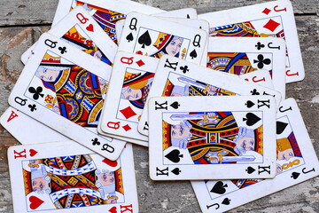 Pile of playing cards at a rustic wooden board.