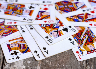 Pile of playing cards at a rustic wooden board.